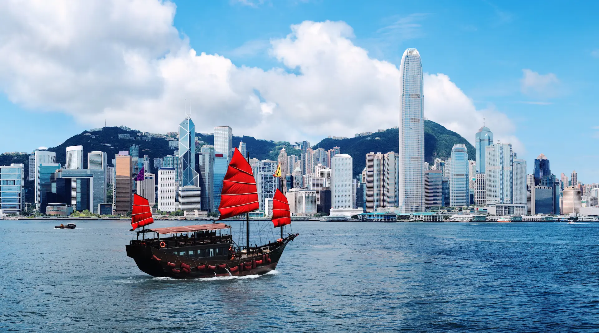 Traditional junk boat with red sails in Victoria Harbour, Hong Kong